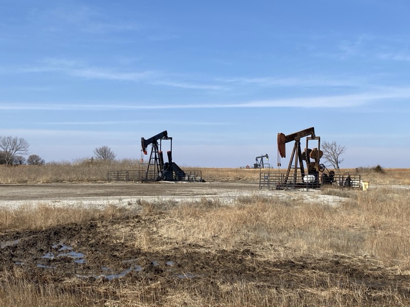 Two pumpjacks operating in the open prairie of Osage County, Oklahoma